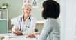 © peopleimages.com - Happy woman, tablet and consulting with patient for medical results, diagnosis or prescription at hospital. Mature person or cardiologist talking to client in consultation with technology at clinic