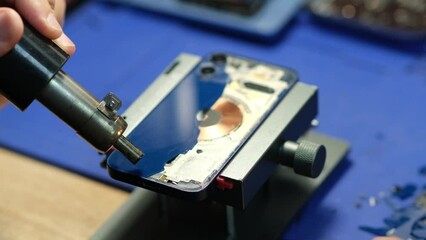 Poster - Smartphone repair in the service, replacement of the rear window. Phone repair in the service.Heats up the smartphone with a hairdryer. Battery Replacement