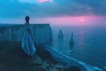 Poster - A person standing at the edge of a cliff looking out at the ocean, potentially contemplating or feeling overwhelmed by the vastness of the sea