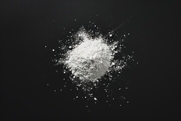 Poster - A small pile of white powder sits on a black surface, offering a striking contrast