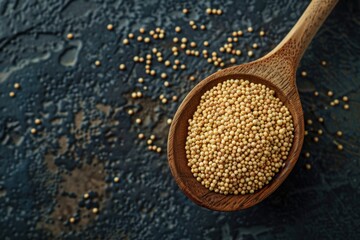 Poster - A wooden spoon filled with yellow mustard seeds