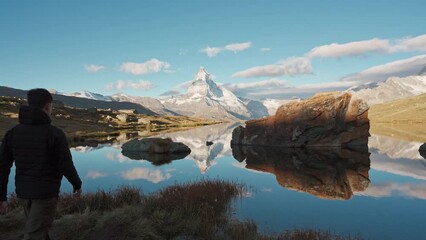 Wall Mural - Traveler man standing and enjoying on Stellisee Lake with Matterhorn mountain in the morning at Switzerland