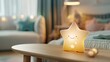 © lililia - A smiling star-shaped night light illuminates a wooden table in a bedroom