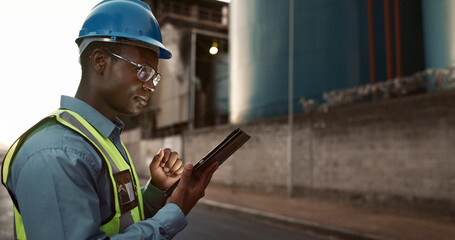 Poster - Construction, online and black man on tablet in city for planning, building and maintenance. Civil engineering, architecture and person on digital tech for project, infrastructure and manufacturing