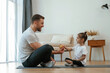 © standret - Giving an apple. Father with little daughter are doing yoga at home