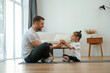 © standret - Giving an apple. Father with little daughter are doing yoga at home