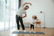 © standret - Spine exercise. Father with little daughter are doing yoga at home