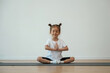© standret - Cute little girl is sitting on the yoga mat and doing exercises