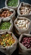 © lililia - A flat lay image of a variety of dried beans and grains, including lentils, black beans, white beans, chickpeas, millet, and red kidney beans, all displayed in small burlap bags on a black surface
