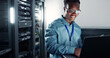 © peopleimages.com - Laptop, server room and technician programming software, update or system network maintenance. Technology, data center or happy black man on database for information, cybersecurity or cloud computing
