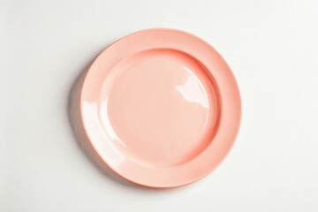 Wall Mural - Empty pink plate on a white background