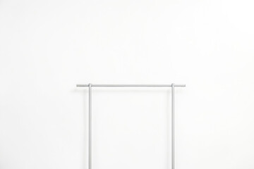 Wall Mural - Minimalist Clothes Rack in Front of a White Wall