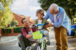 © Geber86 - Father and grandfather teaching young boy to ride a bike on residential street