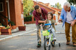 © Geber86 - Father and grandfather teaching young boy to ride a bike on residential street