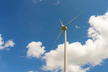 Wind power generator against a cloudy sky.