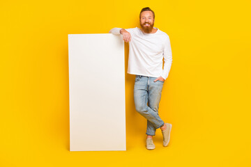 Wall Mural - Full length photo of beard man near big telephone wear shirt jeans shoes isolated on yellow color background