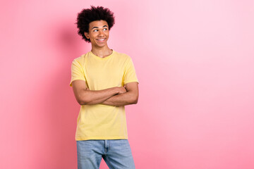 Wall Mural - Portrait of nice young man crossed hands look empty space wear yellow t-shirt isolated on pink color background