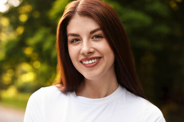 Canvas Print - Portrait of smiling woman in park. Spring vibes