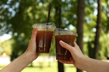 Wall Mural - Women with tasty refreshing drinks outdoors, closeup