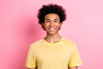 Wall Mural - Photo of cheerful attractive man wear yellow t-shirt smiling showing white teeth isolated pink color background