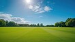 © armensl - cricket field on a sunny day. Cricket pitch empty summer sport green grass field background. cricket pitch on a sunny day.
