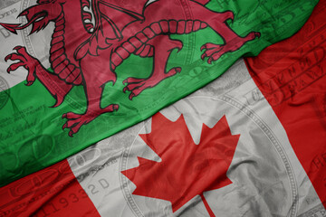Poster - waving colorful flag of wales and national flag of canada on the dollar money background. finance concept.