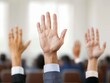 © JP STUDIO LAB - Seminar hall, diverse professionals raising hands during a crucial vote, business attire, serious engagement, presenter moderating the session