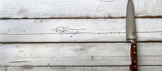 Poster - Rustic kitchen knife displayed on white wooden backdrop with copy space image.