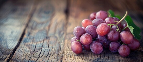 Poster - Grape on a wooden table with copy space image.
