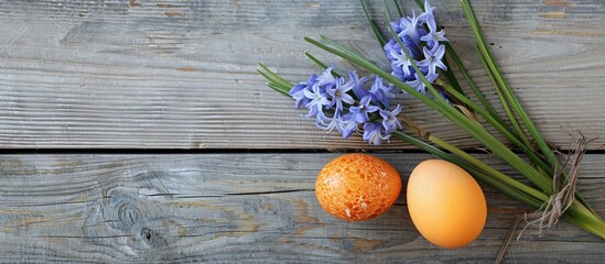 Poster - Naturally dyed Easter egg using onion skins placed with hyacinth flower on wooden background with copy space image.