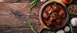 © HN Works - A vivid image of goulash, featuring slices of red beef or lamb on a cutting board surrounded by rosemary, garlic, and peppercorns on a wooden surface, providing ample copy space.