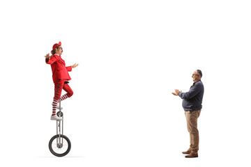 Poster - Mature man giving applause to an acrobat riding a giraffe unicycle