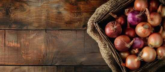 Poster - Onions arranged in a basket on a rustic wooden surface with copy space image.