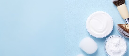Poster - Skin care concept featuring beauty items like hyaluronic acid, a face massage brush, and face cream, displayed on a blue backdrop in a flat lay image with copy space.