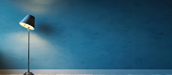 Poster - Blue wall with a classic wall lamp, perfect for displaying text in the copy space image.