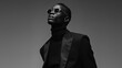 © Anastasiia K. - black man in black clothes on a monochrome background. Black and white photo - Portrait of a serious young afro american man dressed in all black on a minimalistic background