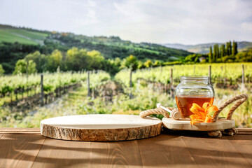 Wall Mural - Glass jar of honey on wooden table with nature background of green garden and trees. Outdoor background and place for advertising products.