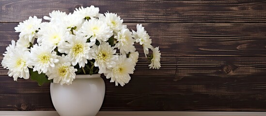 Poster - White chrysanthemums in a white vase on a wooden backdrop, perfect for copy space image.
