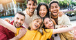 © Davide Angelini - Multi ethnic young people smiling together at camera outdoors - Happy group of friends having fun hanging out in downtown street - University students standing together in college campus