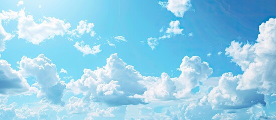 Poster - Summer sky with fluffy clouds set against a blue backdrop provides a picturesque copy space image.