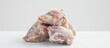 © HN Works - Frozen chicken thighs positioned against a white background with copy space image available.