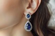 © Alina - Young woman with blue sapphire earrings