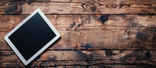 Poster - A tablet computer notebook is shown from above on an office-style wooden floor with ample copy space image.