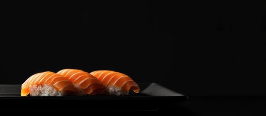 Poster - Salmon temaki sushi displayed on a black plate against a black background, with empty space for additional elements (copy space image).