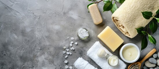 Poster - Spa kit with a range of toiletries including soap bar, shampoo, shower gel, body milk, and a towel, presented in a top view copy space image.
