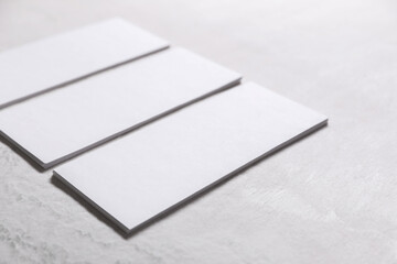 Wall Mural - Blank business cards on light textured table, closeup. Mockup for design