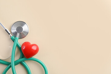 Wall Mural - Stethoscope and red heart on beige background, top view. Space for text