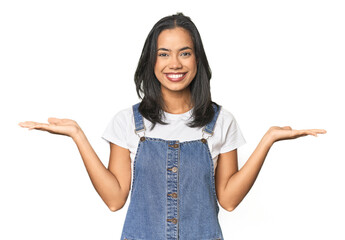 Wall Mural - simple portrait of a young latina makes scale with arms, feels happy and confident.