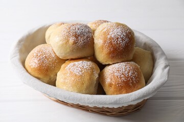 Wall Mural - Delicious dough balls in basket on white wooden table