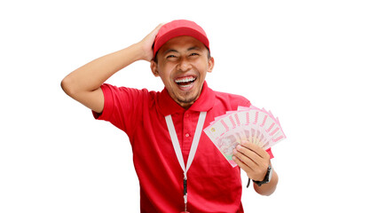 Asian delivery man holds Indonesian Rupiah banknotes in his hand, isolated on white background. Concept of financial success, windfalls, e-commerce, delivery services, and positive financial outcomes